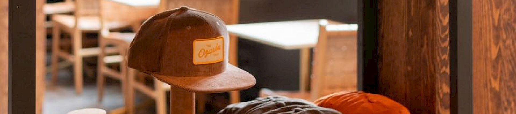 Assorted merchandise hats, t-shirts, books at The Storeroom.