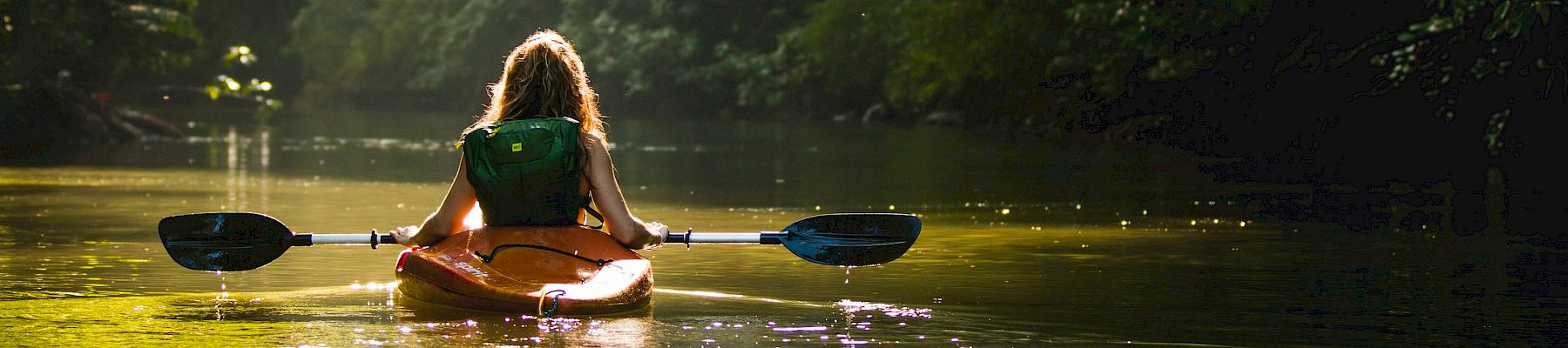A woman kayaking in the river.