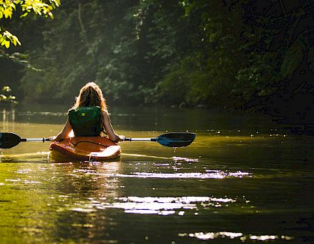 A woman kayaking in the river.