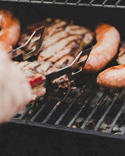 Griiling steaks and sausages.