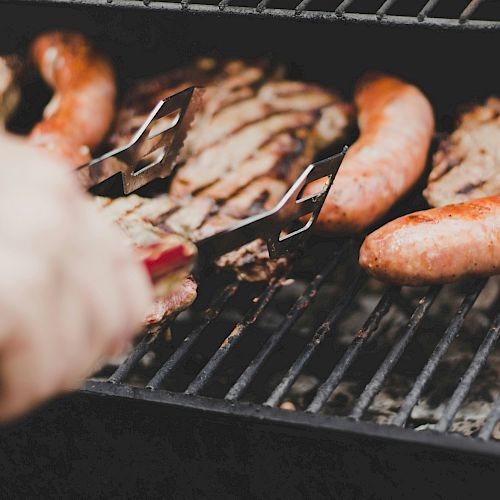 Griiling steaks and sausages.