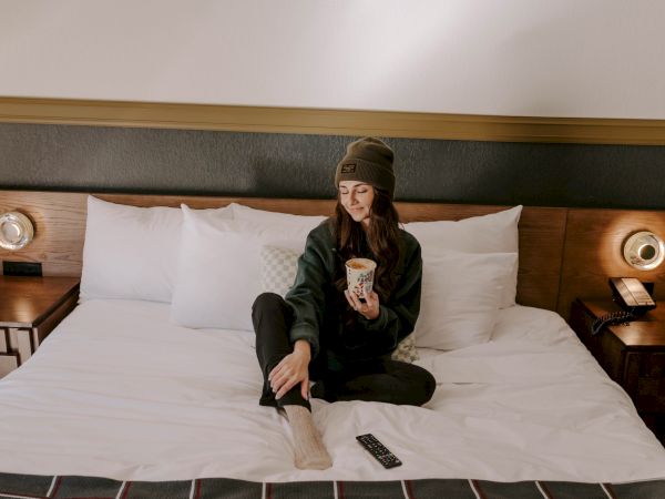 A woman having coffee in bed.